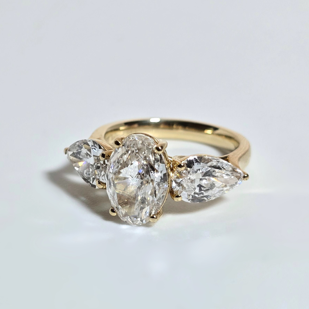 5.00ct Oval Cut Lab Grown Diamond Trilogy Ring with Pear Side Stones in 14ct Yellow Gold