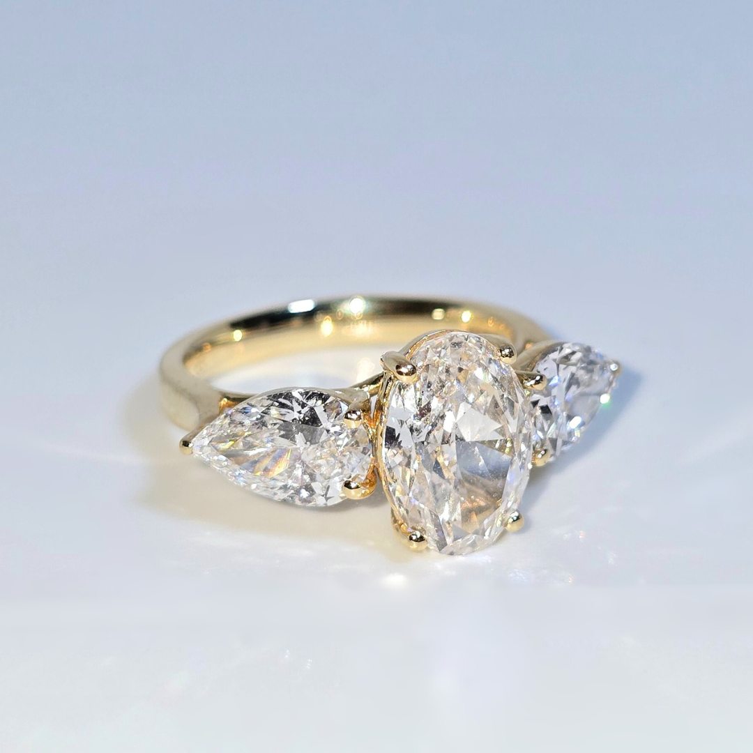 5.00ct Oval Cut Lab Grown Diamond Trilogy Ring with Pear Side Stones in 14ct Yellow Gold
