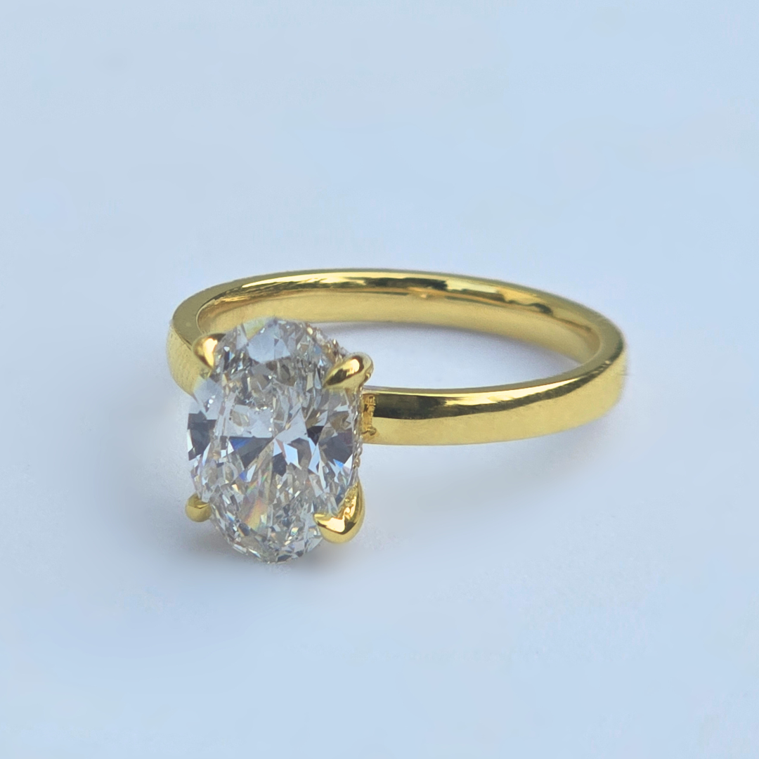 Side view of oval lab diamond solitaire ring with accent diamonds in yellow gold
