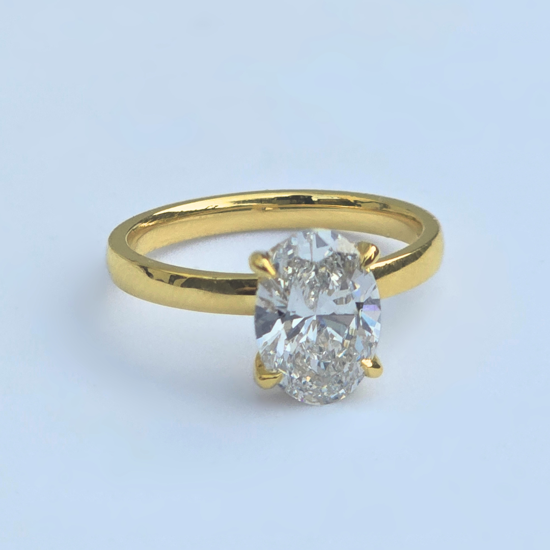 Side view of oval lab diamond solitaire ring with accent diamonds in yellow gold