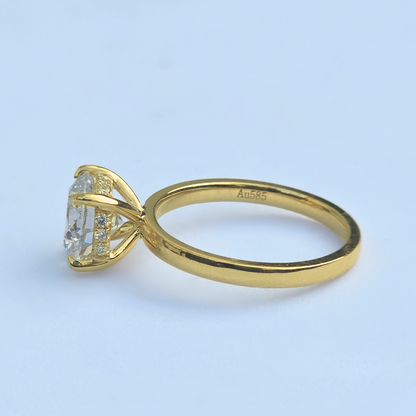 Side view of round brilliant lab diamond solitaire ring with accent diamonds